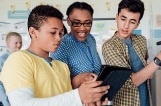 Teen students viewing tablet