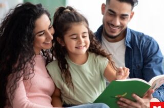 Two adults and a child reading