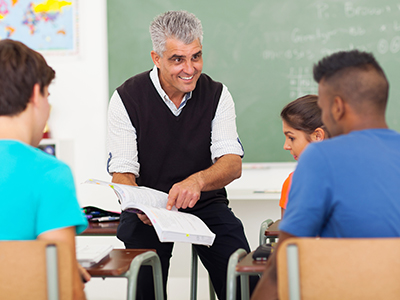 A teacher pointing to a book