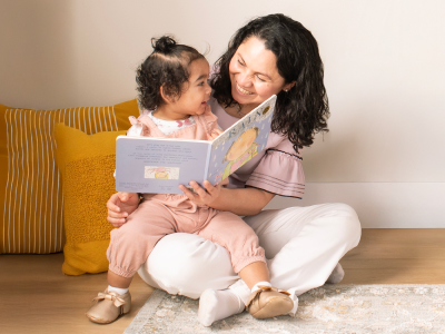A mother reading a book to her daughter