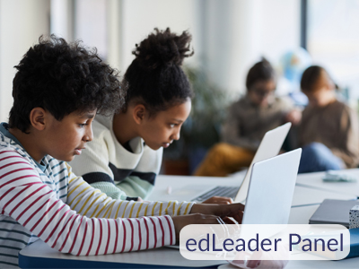 A boy and a girl working on laptops