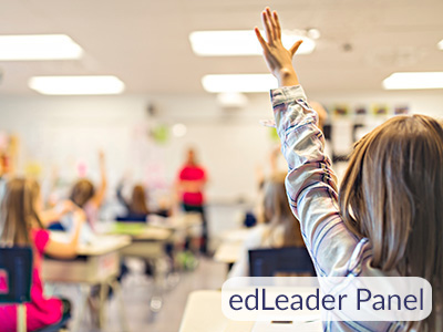 edLeader Panel. Students raising their hands in a classroom.