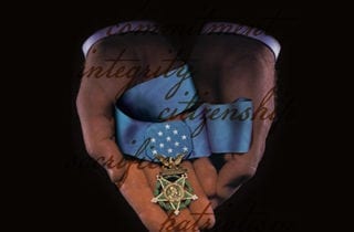 Hands holding the Medal of Honor